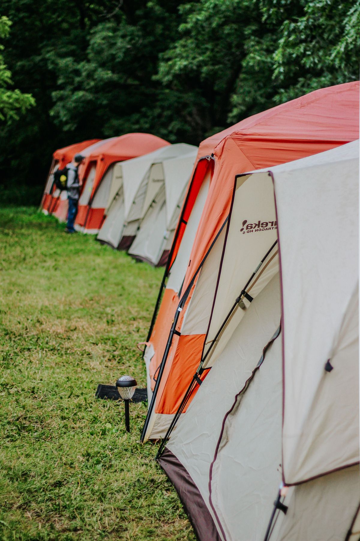 Close view of cabin-style tents with door panels and poles